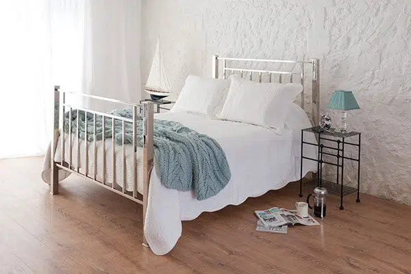 Bronte Nickel double bed – handmade iron and brass bed frame with white bedding and green throw