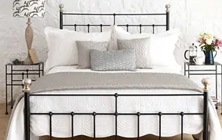 close up of black iron bed