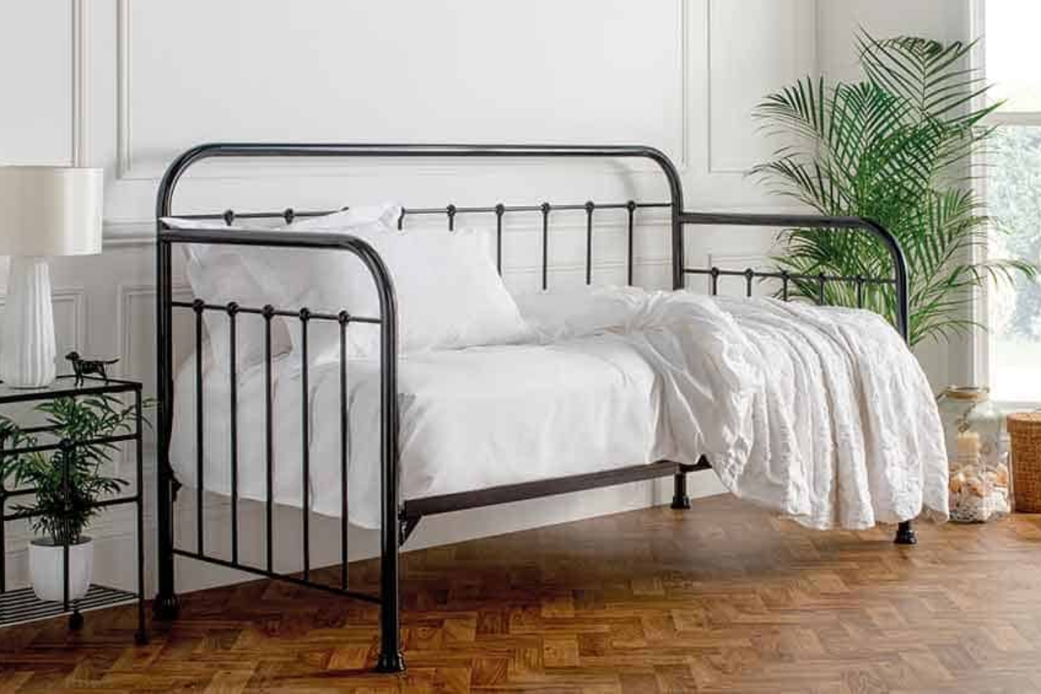 Edward day bed in nickel finish with black details, styled with white bedding in a parquet-floored room
