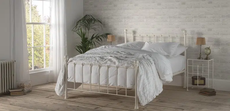 cream iron bed - the image is of a timeless simple iron bed design finished in a cream finish, the bed has a low headboard and low footboard perfect for cottage style bedrooms.