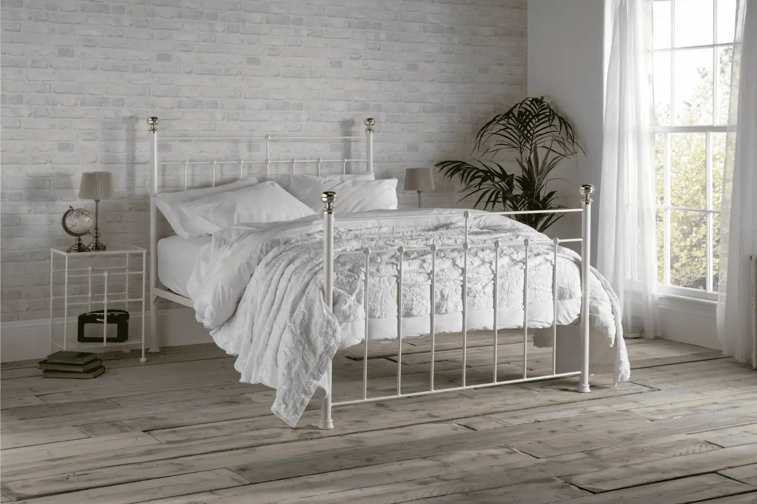 Charlotte white iron bed with elegant curved headboard and white bedding in a classic bedroom
