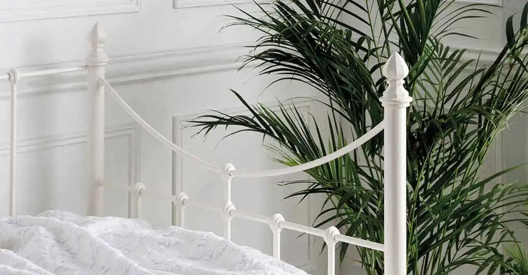 Elegant corner and headboard design of the Emily ivory day bed with soft arches and smooth powder-coated finish