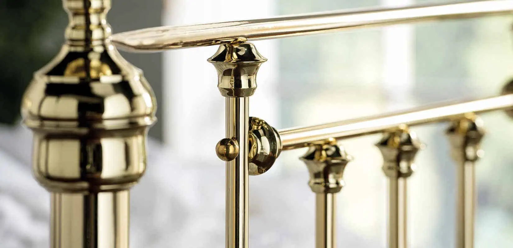 Close-up of Willow bed's brass joints connecting the vertical rods and horizontal rail
