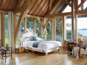 White divan bed in modern lakeside cabin