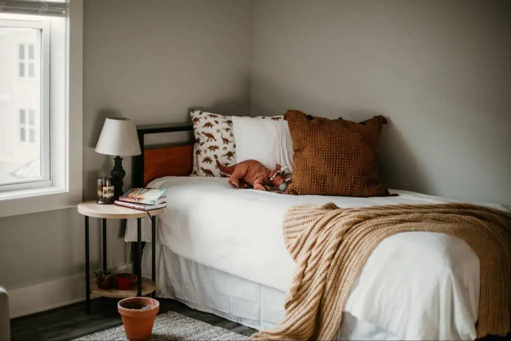 Industrial style single bed in the corner of a room
