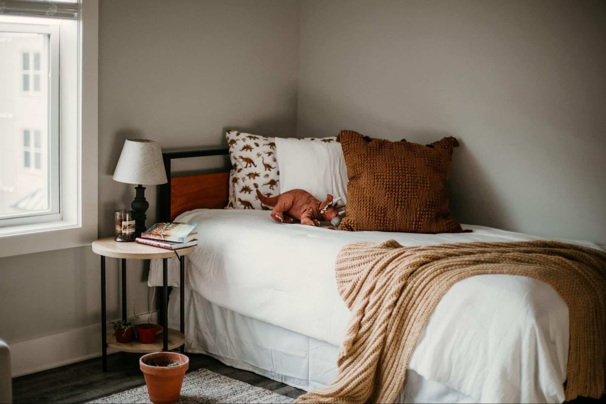 Industrial style single bed in the corner of a room