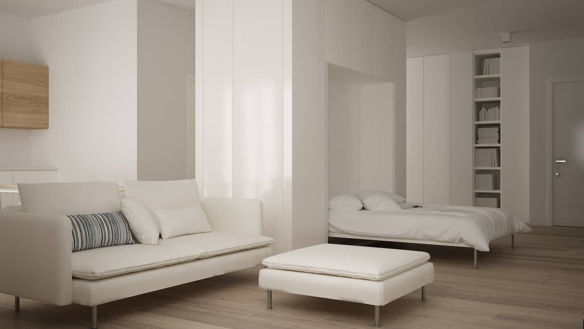 Small apartment with parquet floor, Murphy bed and white sofa in contemporary living room
