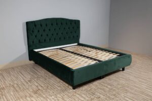 Upholstered bed with a slatted base