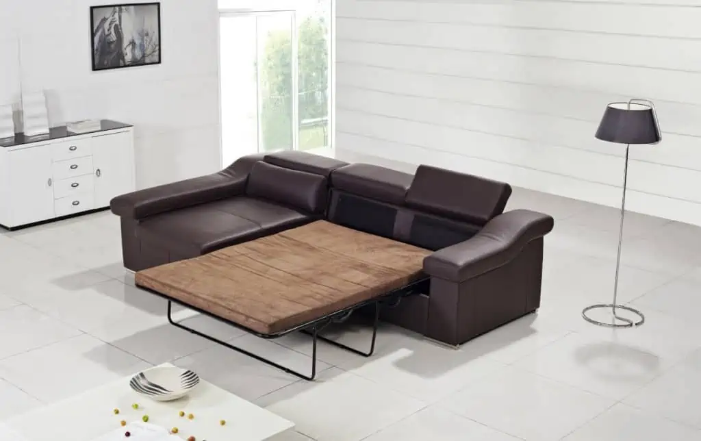 Open brown leather sofa bed