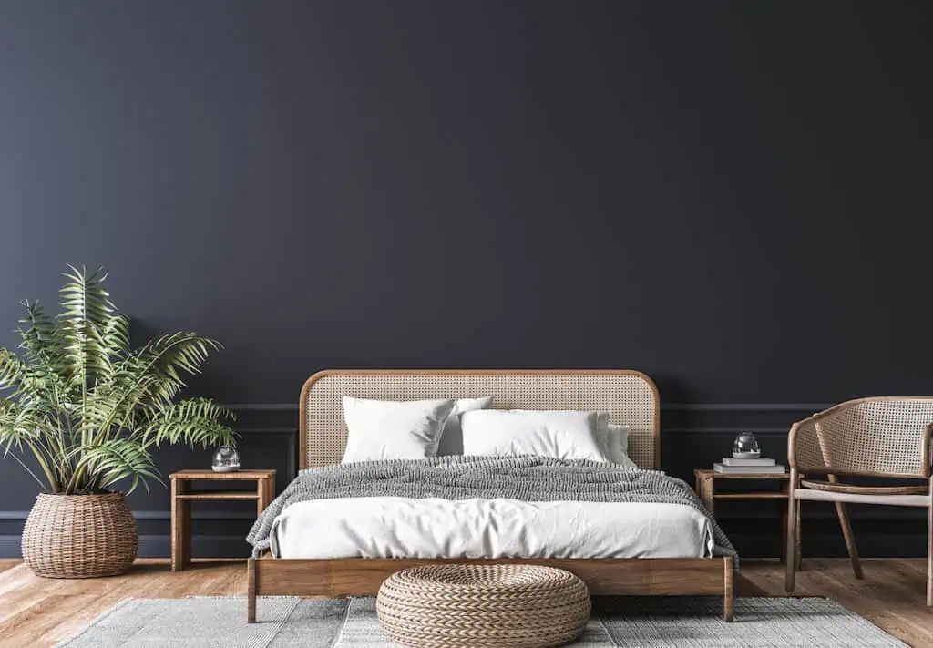 Wooden rattan bed against a dark wall