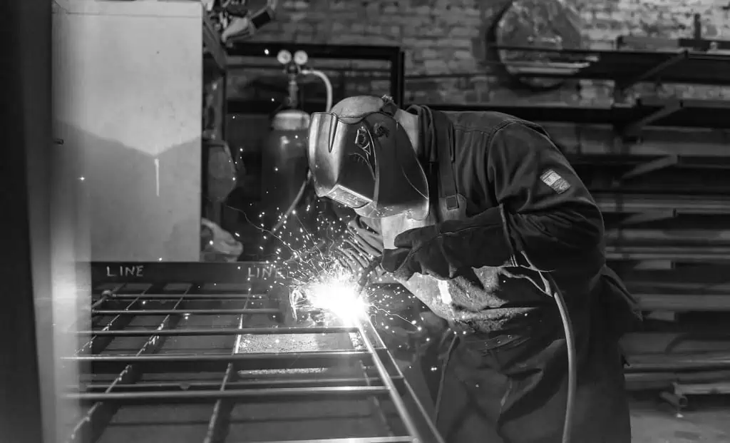 BenefitSummary_masterfully-handcrafted handmade iron bedframe being welded together