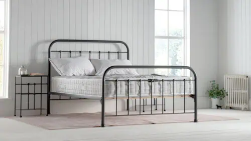 natural fibre mattress on dark grey dormatory style iron bedframe, in a white / coastal inspired bedroom.