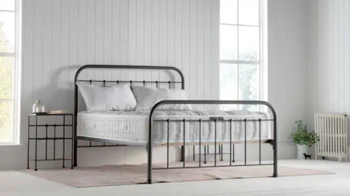 natural fibre 2000 pockey sprung mattress on a dormatory style iron bed in a white painted bedroom with a william morris rug