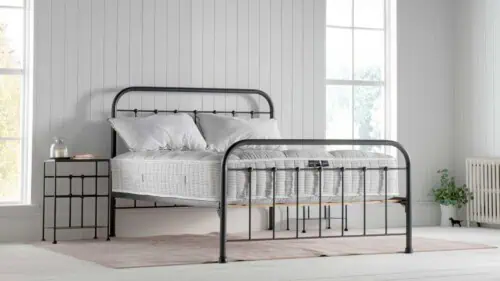 natural fibre pocket sprung mattress layered with wool, cotton and cashmere on an iron bedframe in a white nautical inspired bedroom with two georgian windows