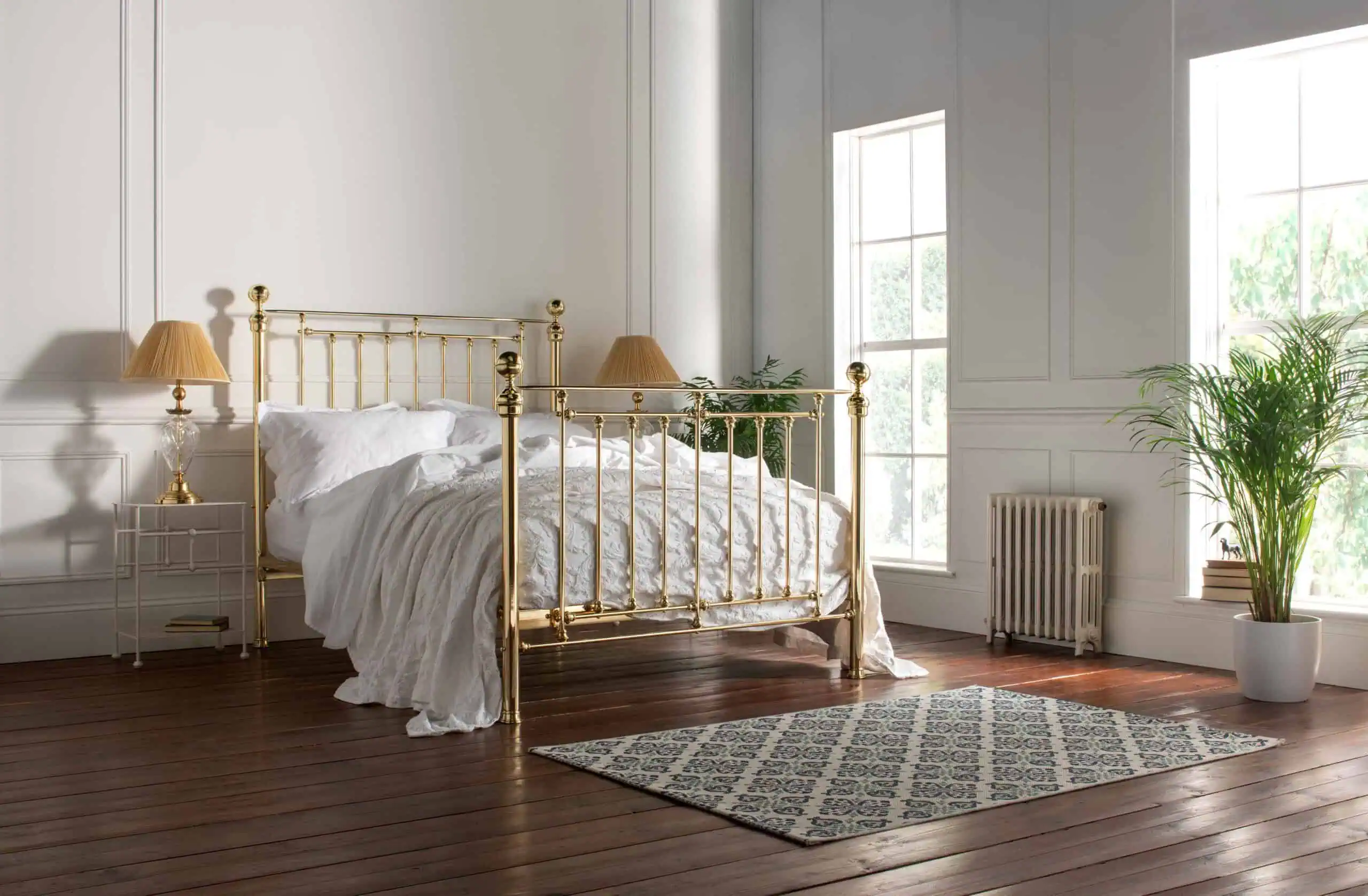 Full view of the Willow brass bed in a classic bedroom setting