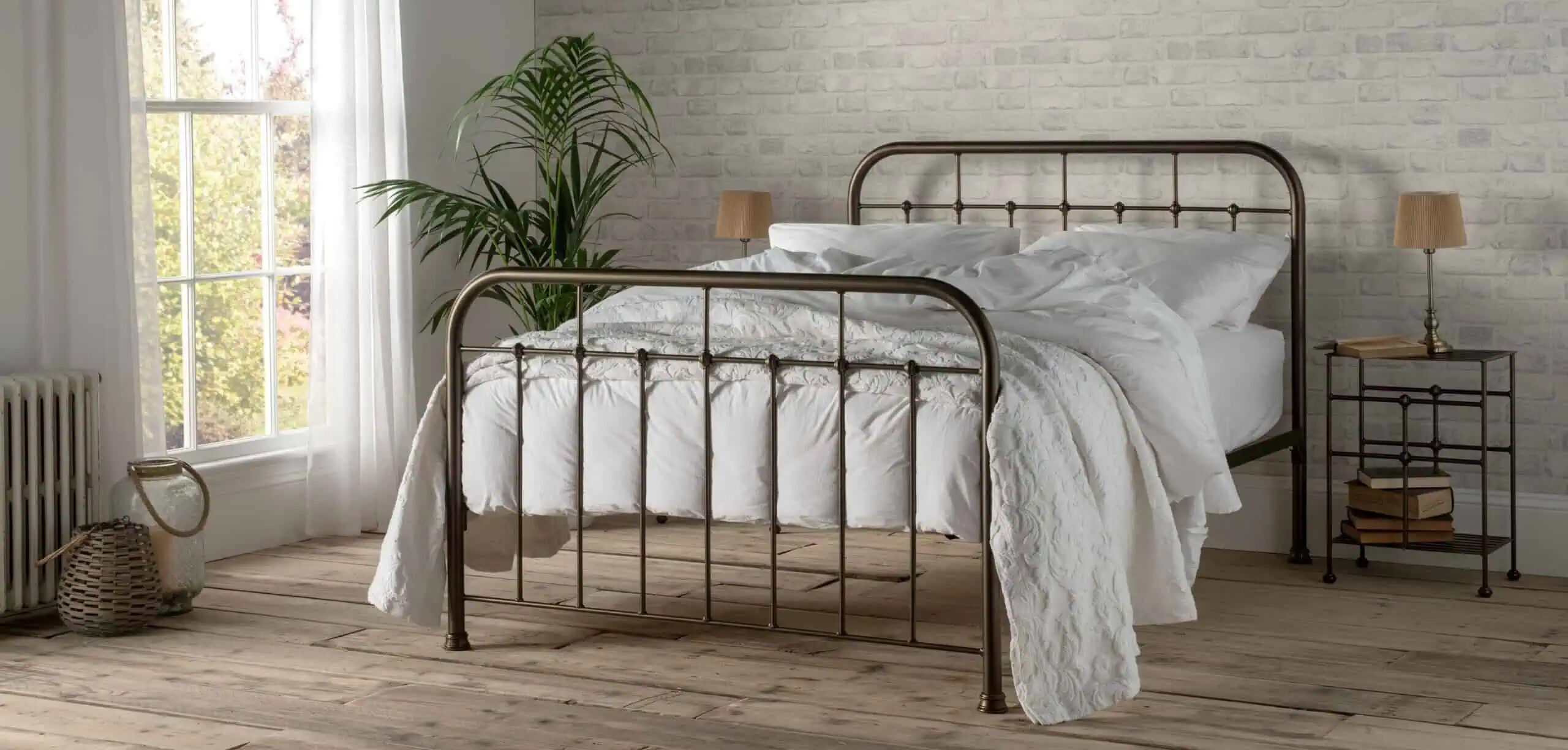 Henry wrought iron bed in bronze with white bedding in bedroom