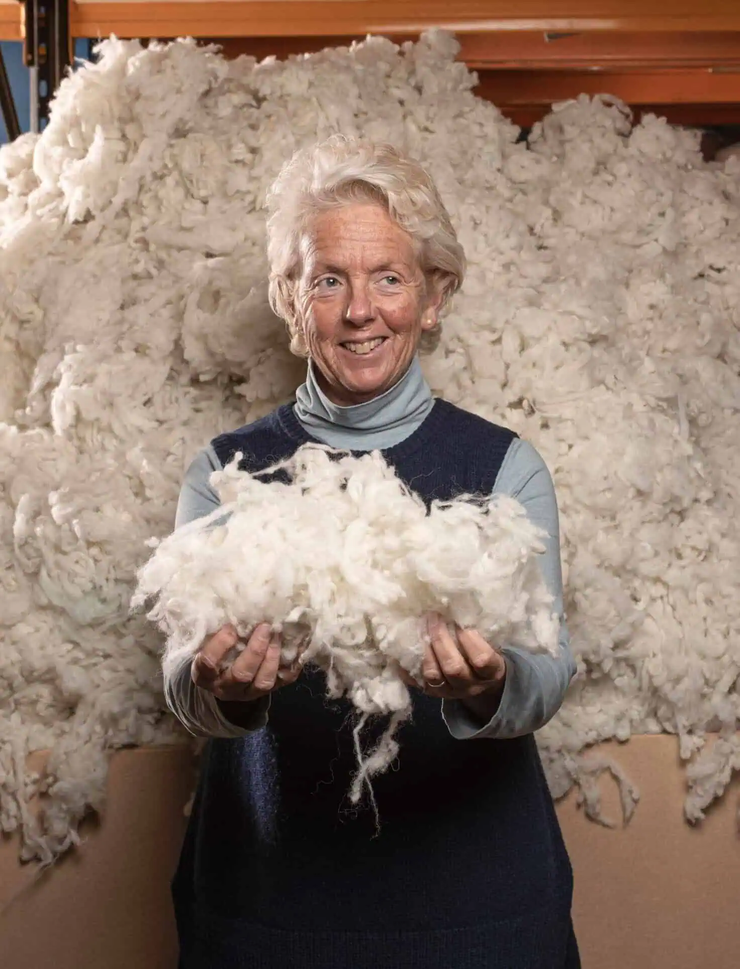 Wrought Iron and Brass Bed Co founder Amanda with raw wool fleece