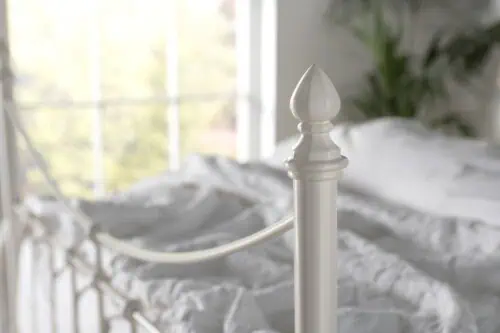 Emili final – timeless detailn on a classic iron bed frame Raw wool fleece