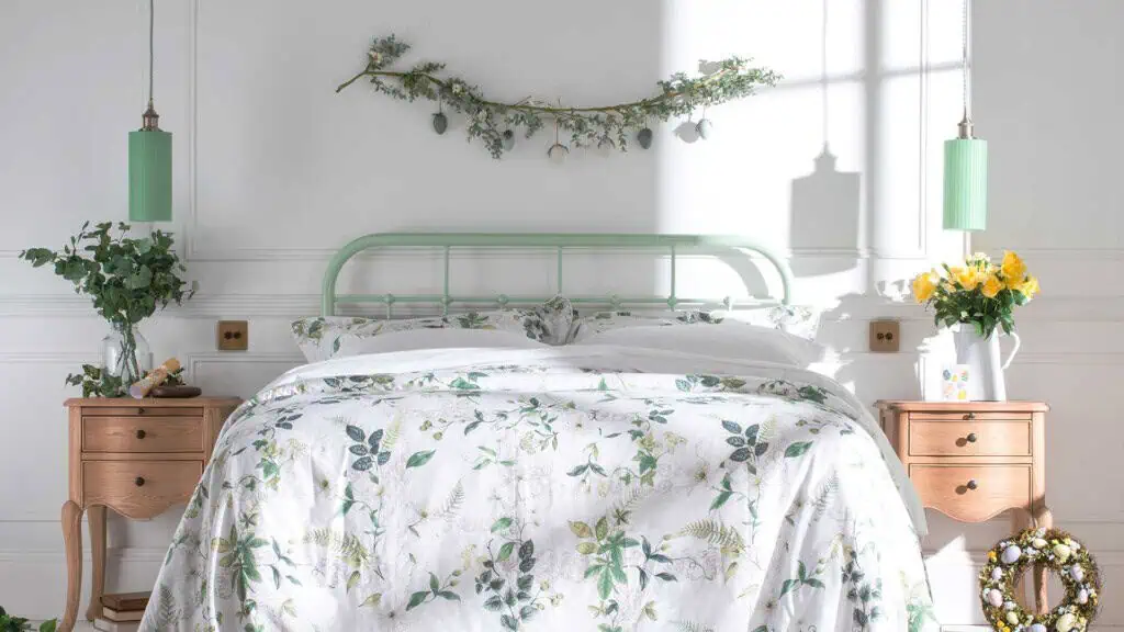 dorm style metal bedframe in mint green with white bedding