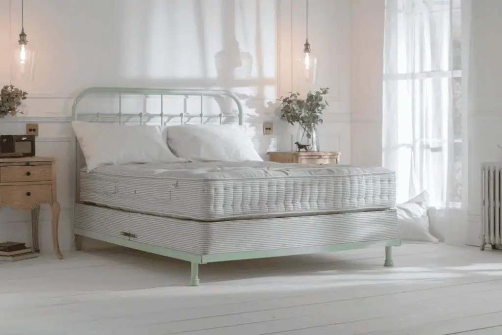 black iron metal bedframe in a country cottage setting