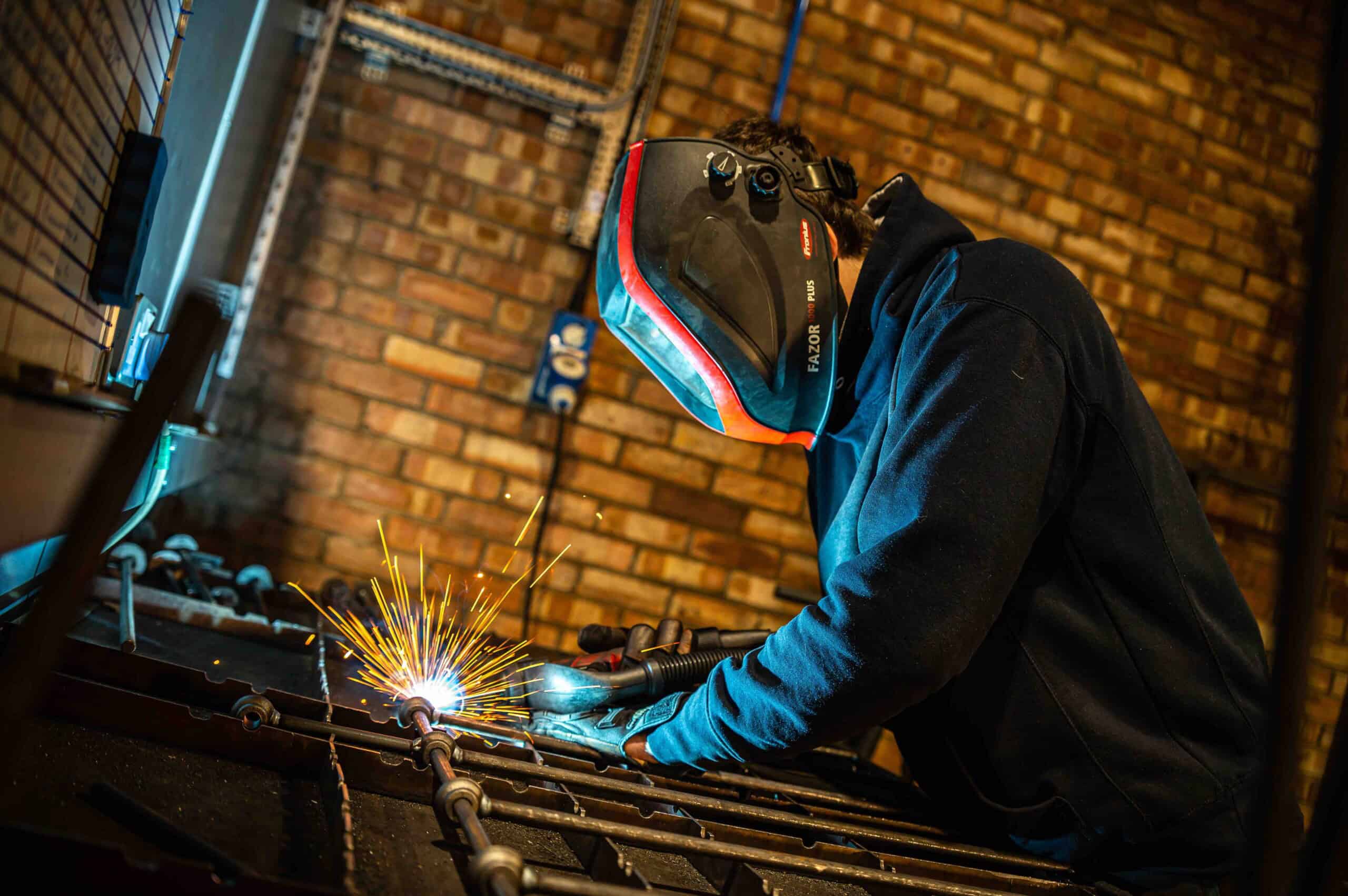 Steel bed frame being assembled by skilled craftsmen