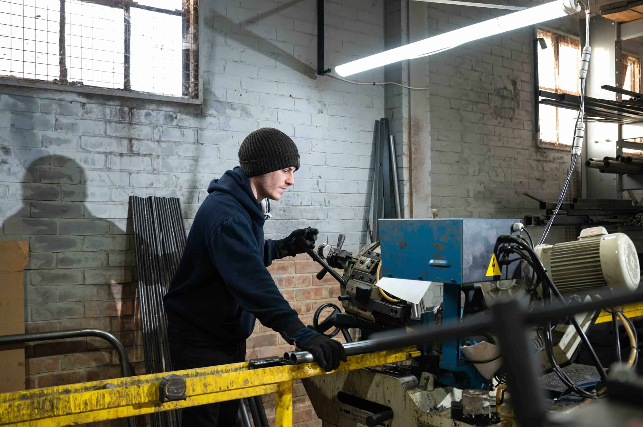 Skilled craftsman shaping metal components by hand