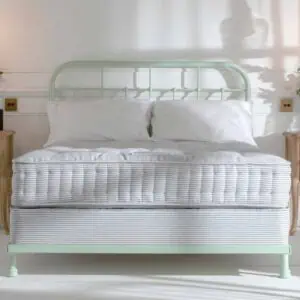 Light green in bright airy bedroom with large windows