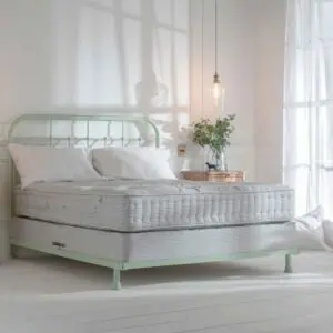 Light green in bright airy bedroom with large windows